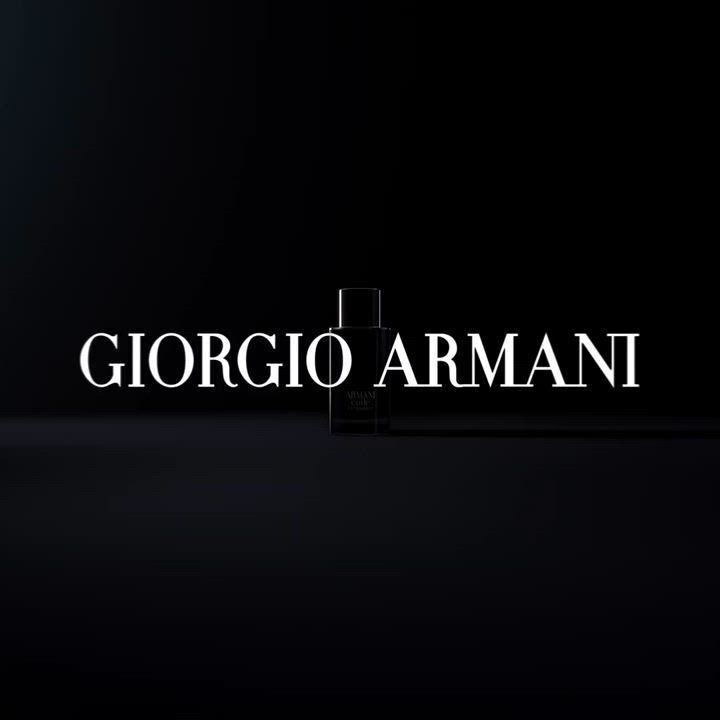 Alt text: A sleek, dark image featuring the logo "GIORGIO ARMANI" prominently displayed in white text, with a silhouette of a perfume bottle in the background.