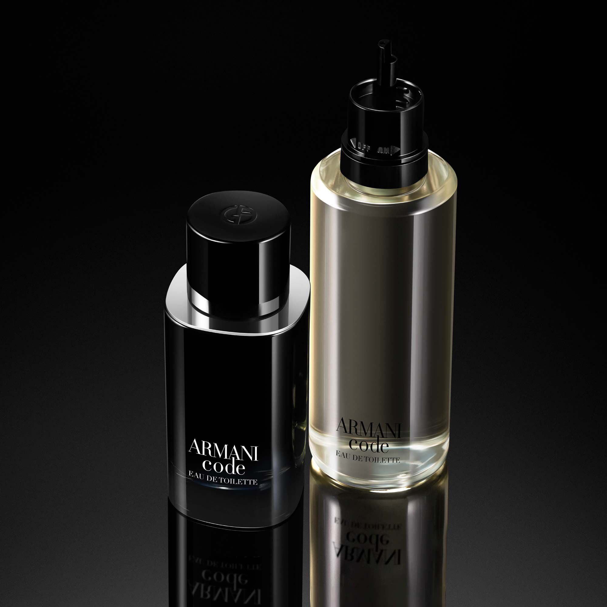 A close-up of two Armani Code fragrance bottles, one with a sleek black design and the other a transparent glass with a gold cap, displayed against a dark background.