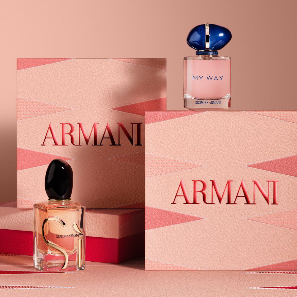 Armani gift sets featuring Si and My Way Eau de Parfum bottles, displayed with elegant pink and red Armani Mother's Day boxes on a matching geometric background.