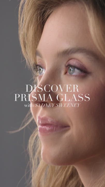 A close-up of a woman with flowing hair, promoting 'Prisma Glass' with the text overlay featuring her name.