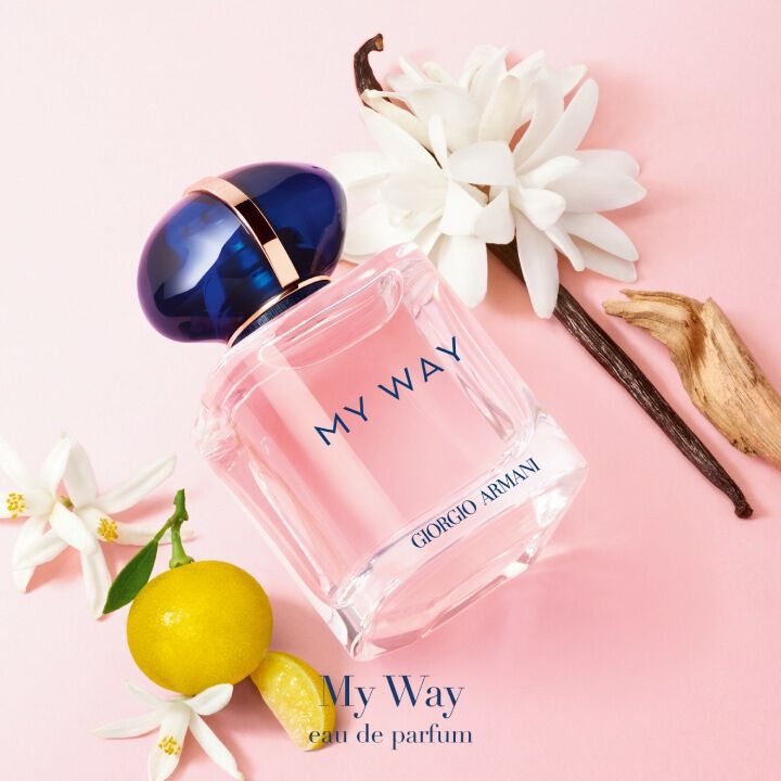 My Way Eau de Parfum bottle with green mandarin, jasmine, and vanilla, arranged on a pink background with natural elements.